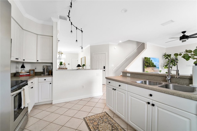 kitchen with white cabinetry, stainless steel electric range oven, sink, and crown molding