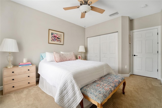 carpeted bedroom with ceiling fan and a closet