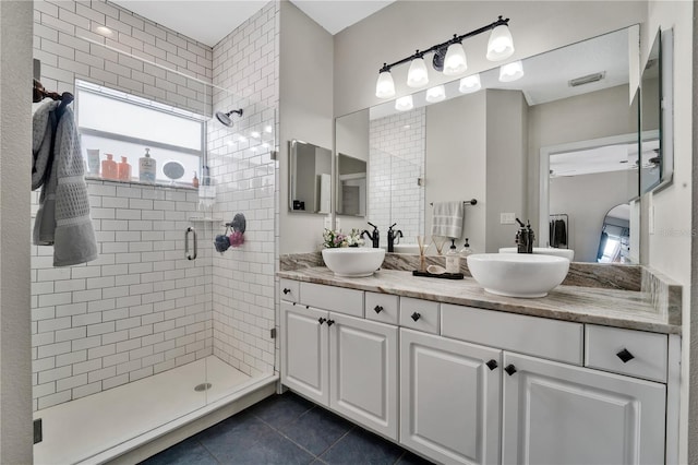 bathroom featuring walk in shower, vanity, and tile patterned flooring