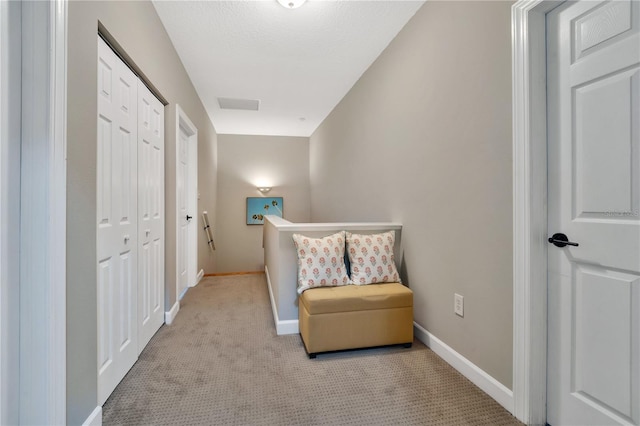 sitting room featuring light colored carpet