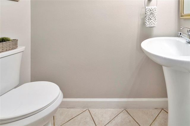 bathroom with tile patterned flooring, sink, and toilet