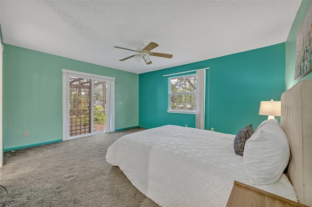 bedroom with ceiling fan, multiple windows, carpet, and a textured ceiling