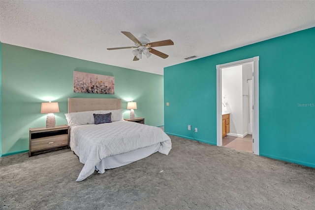 bedroom featuring connected bathroom, ceiling fan, carpet floors, and a textured ceiling