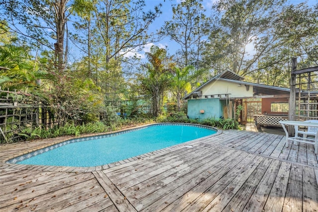 view of swimming pool with a deck