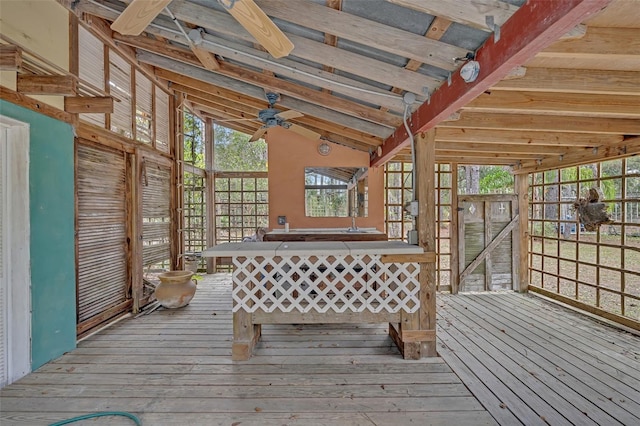 unfurnished sunroom featuring lofted ceiling and ceiling fan