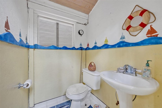 bathroom featuring sink, toilet, and tile patterned flooring