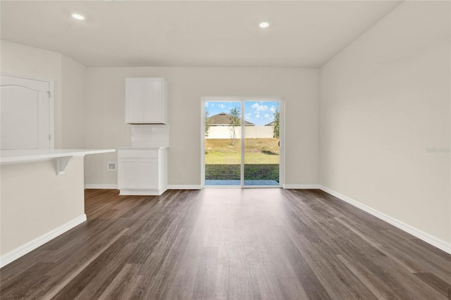 unfurnished living room with dark hardwood / wood-style flooring