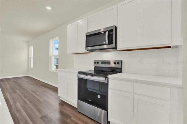 kitchen featuring tasteful backsplash, dark hardwood / wood-style flooring, stainless steel appliances, and white cabinets