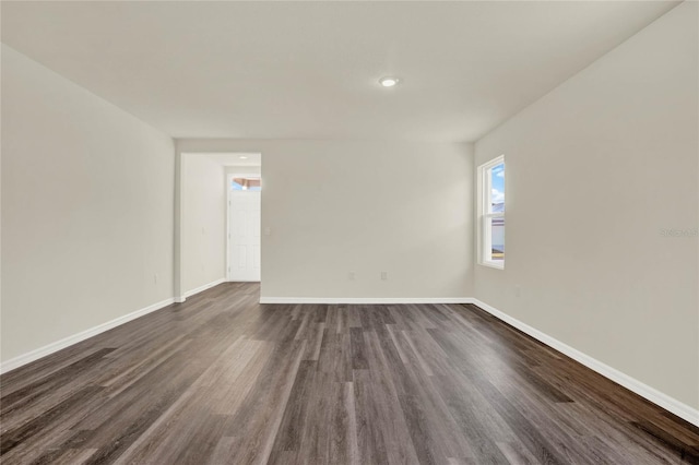 unfurnished room featuring dark hardwood / wood-style floors