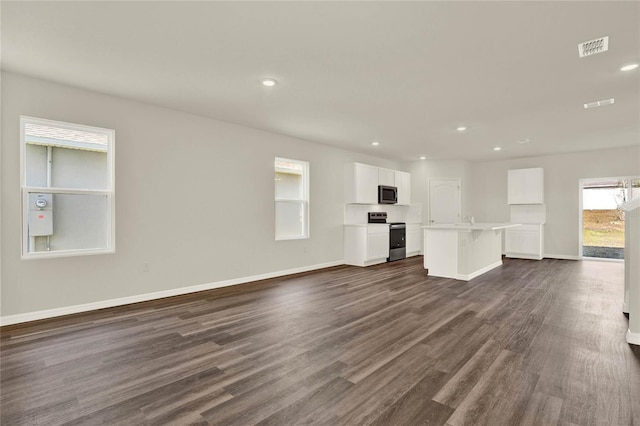 unfurnished living room with dark hardwood / wood-style flooring and sink