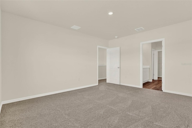 unfurnished bedroom featuring dark colored carpet