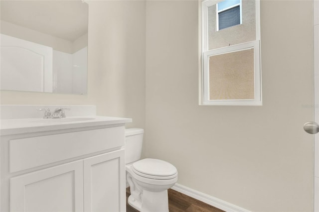 bathroom featuring vanity, wood-type flooring, and toilet