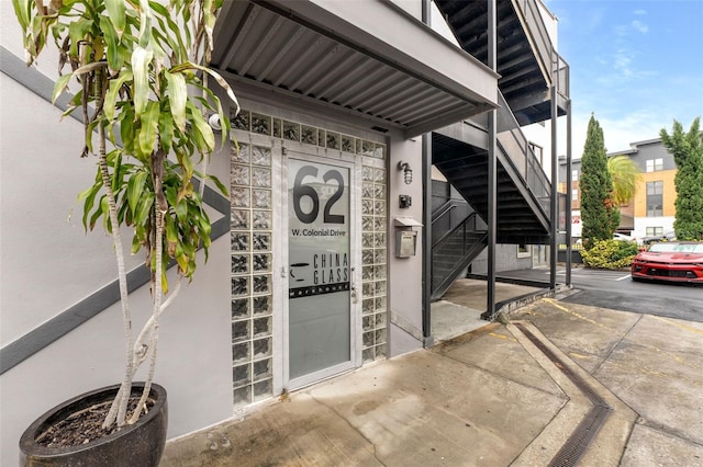 entrance to property featuring stucco siding