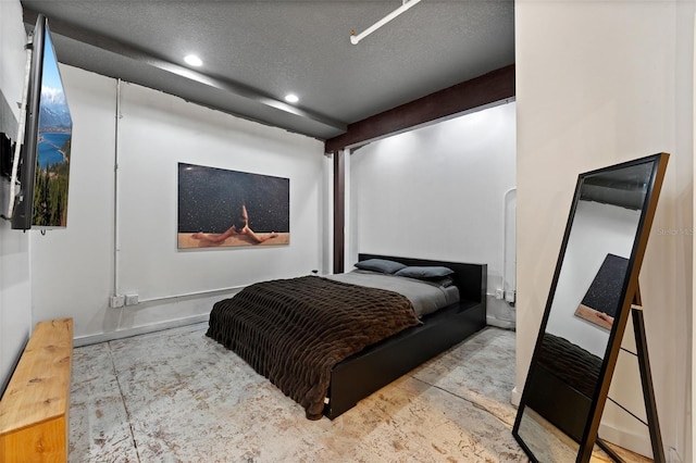 bedroom featuring arched walkways, concrete floors, a textured ceiling, and recessed lighting