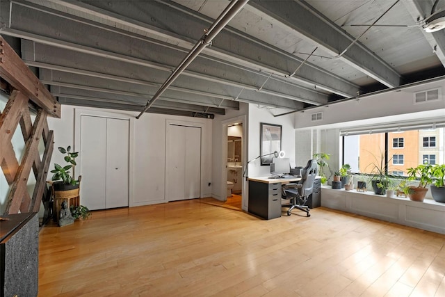 office space with visible vents and light wood-style floors