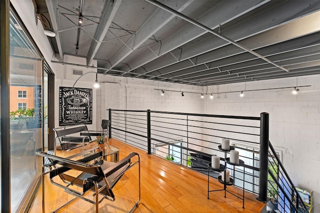 interior space with brick wall and wood finished floors