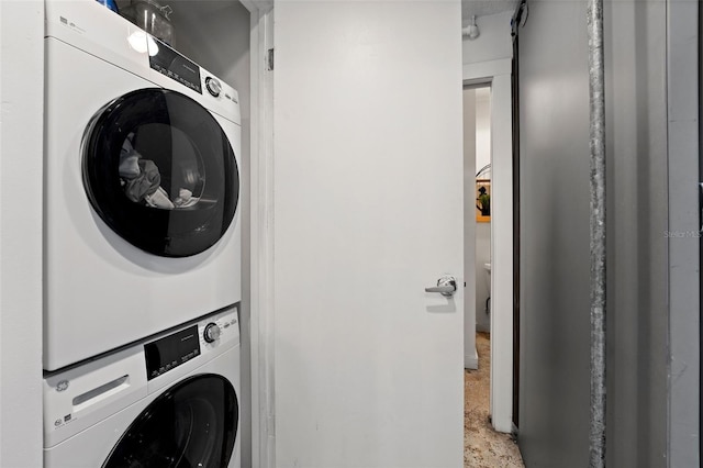 laundry area featuring stacked washer and dryer and laundry area