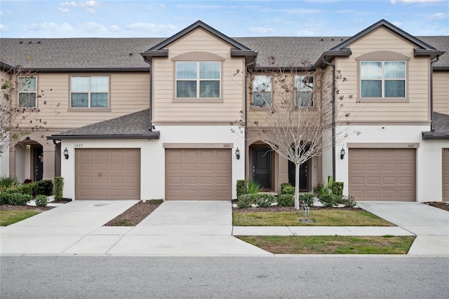 townhome / multi-family property featuring a garage