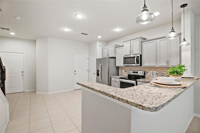 kitchen featuring kitchen peninsula, decorative light fixtures, light stone counters, appliances with stainless steel finishes, and decorative backsplash