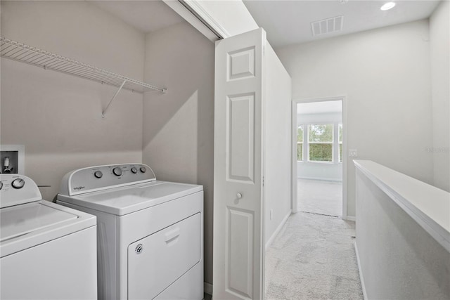 laundry room with light carpet and washer and clothes dryer