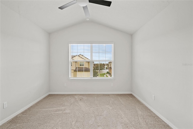 unfurnished room featuring vaulted ceiling, carpet flooring, and ceiling fan