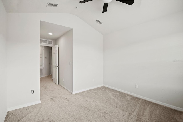 carpeted empty room featuring ceiling fan and vaulted ceiling