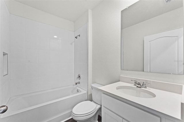 full bathroom with tiled shower / bath, vanity, and toilet