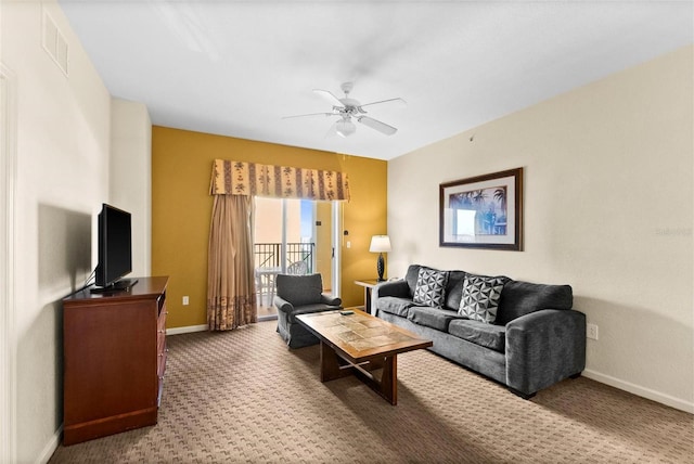 carpeted living room with ceiling fan