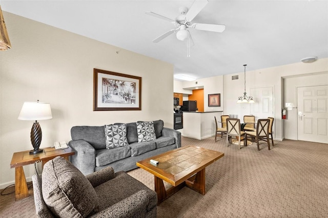 carpeted living room with ceiling fan