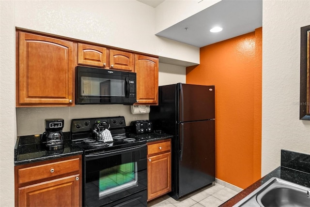 kitchen with light tile patterned floors and black appliances