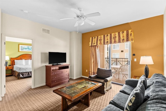 carpeted living room with ceiling fan