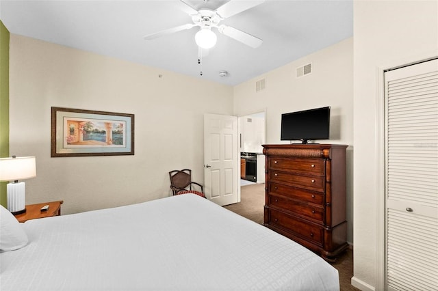 carpeted bedroom featuring ceiling fan and a closet