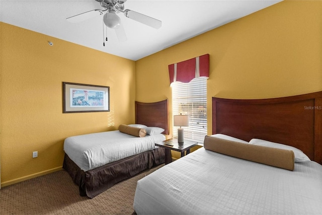 bedroom featuring ceiling fan and carpet