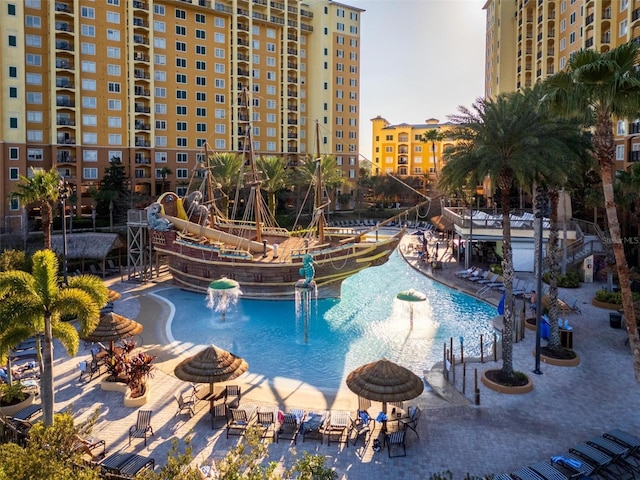 view of swimming pool with pool water feature