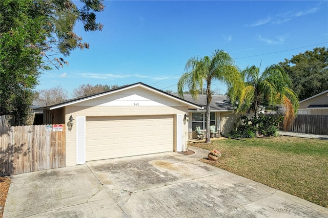 ranch-style house with a front yard and a garage