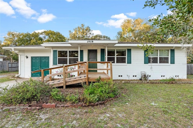 view of front facade featuring a front lawn and a deck