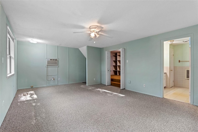 unfurnished bedroom with connected bathroom, light colored carpet, and a textured ceiling