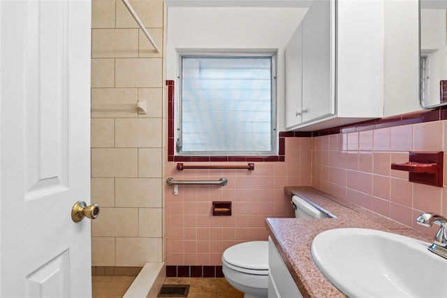 bathroom featuring tile walls, vanity, walk in shower, toilet, and tile patterned floors