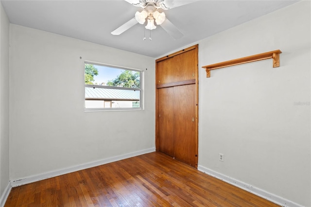 empty room with hardwood / wood-style flooring and ceiling fan