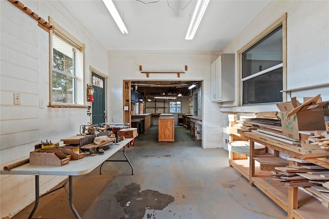 misc room featuring concrete flooring and a workshop area