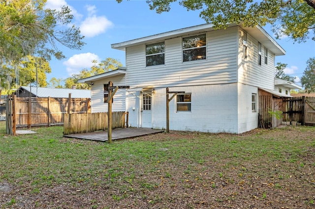 back of house with a lawn