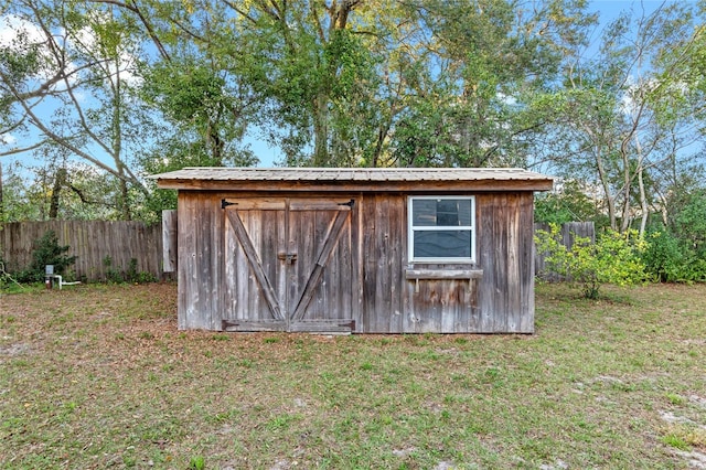 view of outdoor structure featuring a lawn