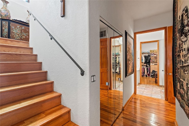 staircase with wood-type flooring