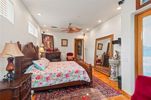 bedroom with hardwood / wood-style flooring and ceiling fan