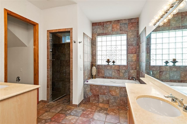 bathroom with vanity and separate shower and tub