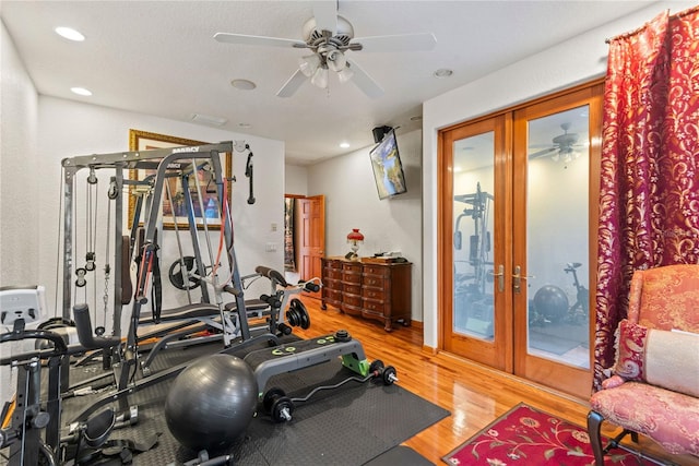 exercise room with french doors, ceiling fan, and hardwood / wood-style floors