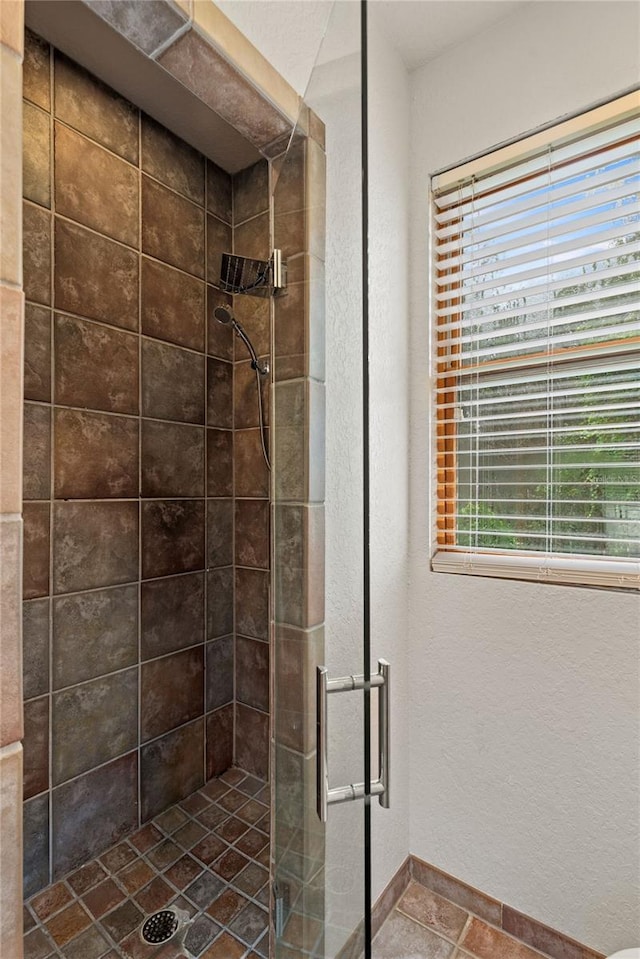 bathroom with a shower with door