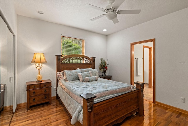 bedroom with hardwood / wood-style floors, ensuite bathroom, a textured ceiling, and ceiling fan