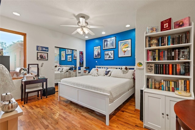 bedroom with ceiling fan and light hardwood / wood-style flooring