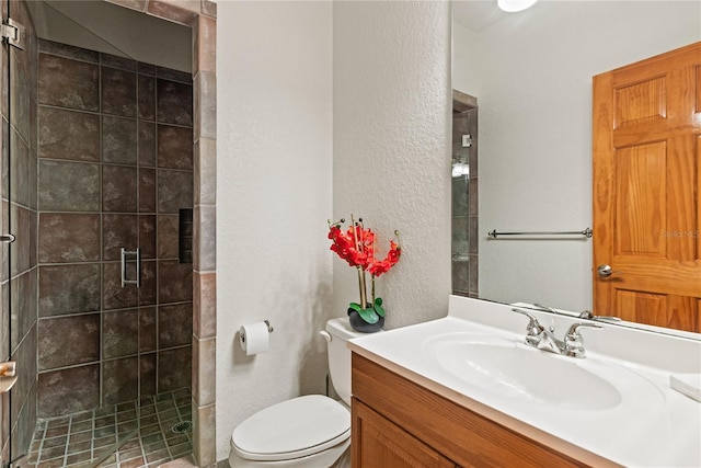 bathroom featuring walk in shower, vanity, and toilet